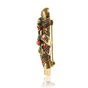 Side view of vintage Santa cane brooch with red and green rhinestones on gold metal