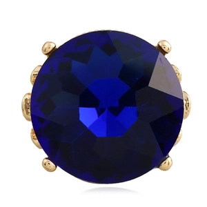 Deep blue round multifaceted gemstone ring with gold prong setting on white background