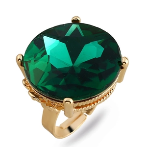Detail view of the large emerald green gemstone set in a vintage golden adjustable ring