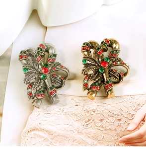Macro detail of Christmas candy cane brooch with red and green rhinestones