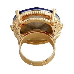 Vintage gold ring with large faceted deep blue gemstone and intricate filigree details