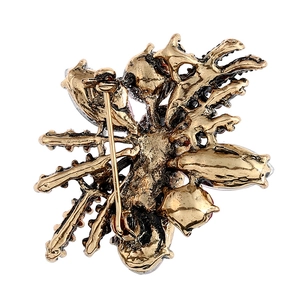 Antique gold vintage brooch back view with metal pin and colorful gemstones detail