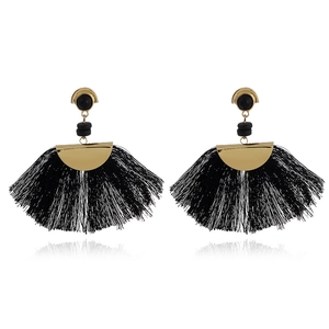 Close-up of bohemian fan-shaped earrings with dense black long thread tassels and gold detail