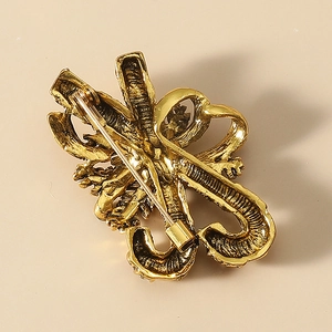 Vintage gold-plated Santa cane brooch back view with secure safety pin clasp detail