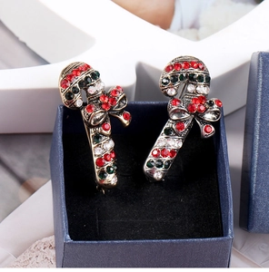Close-up of Christmas candy cane brooches with red, green and white rhinestones