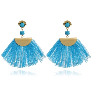 Detail of bohemian fan-shaped earrings with bright blue tassels and golden metal