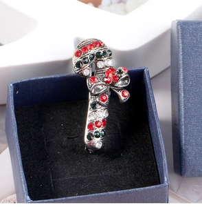 Close-up of sparkling Christmas cane brooch with colorful rhinestones in a blue gift box