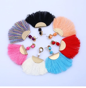 Macro view of colorful bohemian fan-shaped tassel earrings arranged in a circle