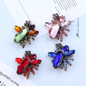 Vintage gold insect brooches with colorful crystals and rhinestones in four elegant colors