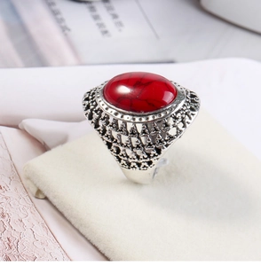 Detailed side view of vintage silver ring featuring a large oval red turquoise stone inlay