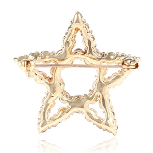 Star-shaped festive brooch in gold metal with hollow design and back pin detail