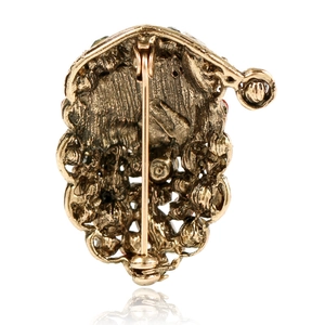 Detail view of vintage gold Christmas brooch back showing pin clasp and metal texture
