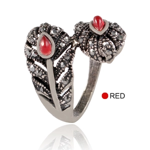 Detalle del anillo de hoja calada vintage en plata con piedras rojas de lágrima