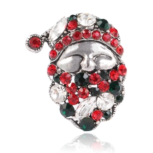 Detailed view of Santa Claus brooch with sparkling red and green rhinestones and silver base