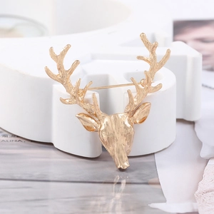 Macro side view of creative hollow deer head brooch in matte gold alloy finish