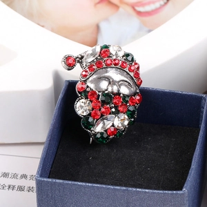 Detailed close-up of a vintage silver Santa Claus brooch with red and green rhinestones