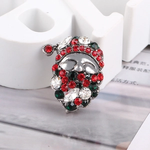 Macro view of Santa Claus brooch with sparkling red, green, and white rhinestones
