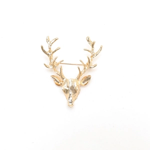 Golden alloy deer head brooch with hollow antlers displayed on white background