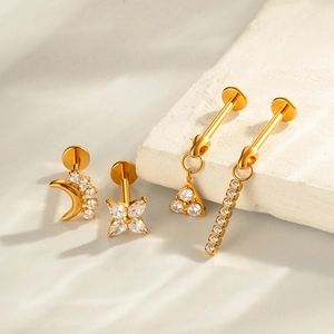 G23 titanium threadless gold piercing set with moon and clover star designs