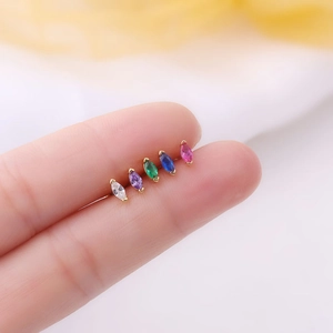 Macro view of colorful marquise cubic zirconia earrings with gold plated 20G titanium studs