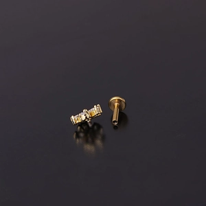 Detailed close-up of 16G gold steel piercing jewelry with micro-set zircon and screw thread