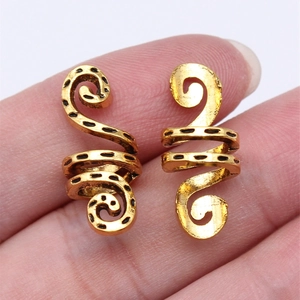Spiral gold dreadlock beads with geometric black patterns for bohemian hair styling
