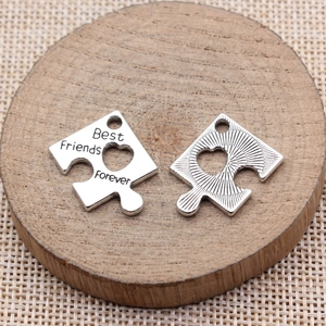 Silver puzzle piece pendant set with heart cutout and Best Friends Forever engraving