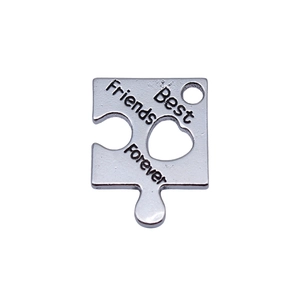 Silver puzzle piece pendant with heart cutout and Best Friends Forever engraving