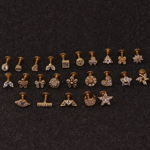 Macro view of gold-plated stainless steel studs with star and flower zircon patterns