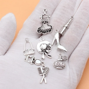 Set of 7 vintage silver alloy charms featuring lipstick, perfume and high heel shapes
