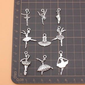 Set of 9 antique silver ballet pendants featuring dancers, shoes and tutu dresses