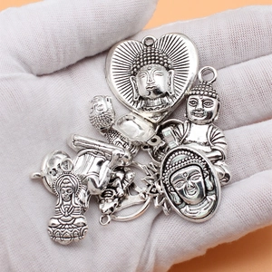 Set of 15 antique silver Buddha charm pendants with detailed metal embossed patterns