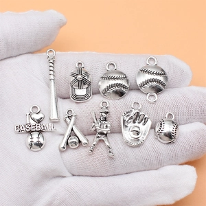 Set of 9 antique silver baseball charms featuring bats, caps, players and gloves