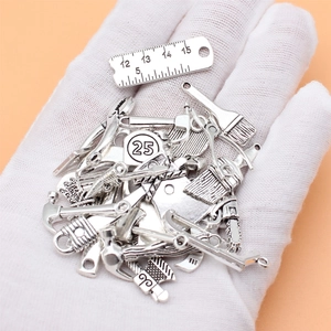 Set of 25 miniature silver alloy tool pendants including saws and pliers for DIY jewelry