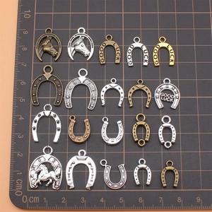 Set of 20 mixed lucky horseshoe pendants in gold silver and bronze metal finishes