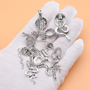 Set of antique silver snake pendants featuring 12 unique cobra styles for DIY jewelry making