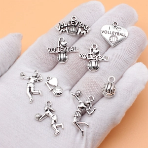 Set of vintage silver volleyball charms including sports figures and 'Volleyball Mom' text