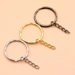 Three metal keyrings in silver, gold, and bronze with a textured hammered finish and 4-link chain