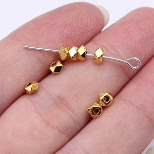 Facettierte 3,6 mm geometrische Goldperlen für DIY-Schmuck zur Größenvorstellung auf der Hand