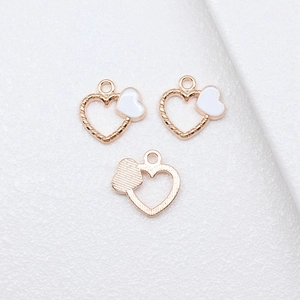 Three rose gold heart pendants with rope texture and white enamel inlays for DIY jewelry
