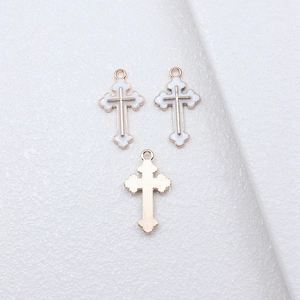 Golden cross pendant with white enamel inlay and wavy edges for DIY jewelry making