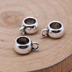 Three vintage silver DIY mini coffee cup charms for jewelry making on wooden background