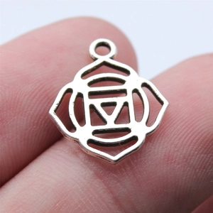 Silver 7 Chakra yoga pendant on a finger to show its miniature 15x18mm scale