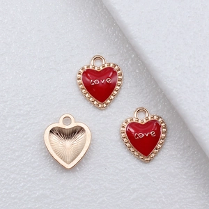 Three red heart-shaped enamel LOVE charms with gold beaded edges and texture on the back