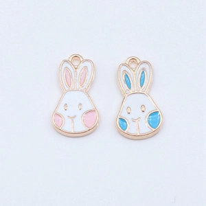 Enamel rabbit charms in pink and blue with gold alloy frames for DIY jewelry crafting