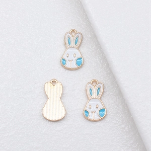 Three colorful bunny alloy enamel pendants for DIY jewelry making on white background