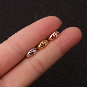 Detailed view of mini heart-shaped earrings in silver, gold, and rose gold with flower cutouts