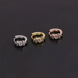 Detailed trio of silver, gold, and rose gold floral hoop earrings with zircon stones