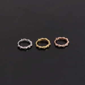 Detailed view of silver, gold and rose gold huggie hoop earrings with micro cubic zirconia