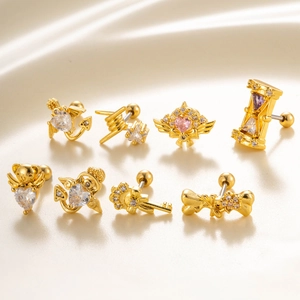 Detailed view of gold screw-back earrings with zircon crystals on satin fabric